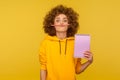 Portrait of young woman in urban style hoodie holding pencil with her lips, pretending to have mustache Royalty Free Stock Photo