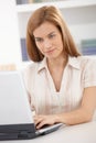 Portrait of young woman using laptop smiling Royalty Free Stock Photo