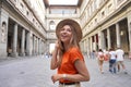 Portrait of young woman walking in courtyard of historic Uffizi Gallery art museum in Florence, Tuscany, Italy