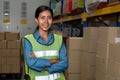 Portrait of young woman warehouse worker smiling in the storehouse Royalty Free Stock Photo