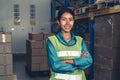 Portrait of young woman warehouse worker smiling in the storehouse Royalty Free Stock Photo