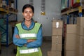 Portrait of young woman warehouse worker smiling in the storehouse Royalty Free Stock Photo