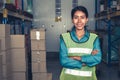 Portrait of young woman warehouse worker smiling in the storehouse Royalty Free Stock Photo