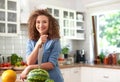 Young woman with watermelon and a knife stabbed in