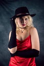 Portrait of young woman wear red dress and hat  on dark background Royalty Free Stock Photo