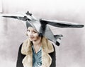 Portrait of a young woman wearing an airplane shaped cap