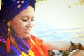 Portrait of a young woman wearing boho chic headband and handmade feathers necklace and earrings Royalty Free Stock Photo