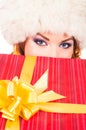 Portrait of a young woman in a winter hat holding a present Royalty Free Stock Photo