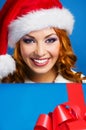 Portrait of a young woman in a winter hat holding a present Royalty Free Stock Photo