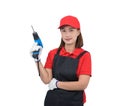 Portrait of young woman worker smiling in red uniform with apron, glove hand holding electric drill isolated on white backround Royalty Free Stock Photo