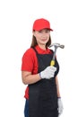 Portrait of young woman worker smiling in red uniform with apron, glove hand holding hammer isolated on white backround Royalty Free Stock Photo