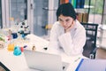 Portrait of young woman working with laptop in science lab Royalty Free Stock Photo