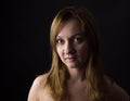 Portrait of young woman on yelllow cole field background