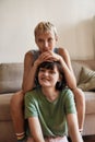 Portrait of young women looking happy while cuddling, relaxing at home. Lesbian couple spending time together indoors Royalty Free Stock Photo