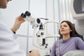 Optometrist Setting Up Equipment while Examining Patient
