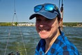 Portrait of a young yachtswoman driving a yacht.