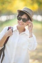 portrait of younger asian woman wearing sun glassess toothy smiling face