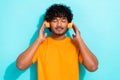 Portrait of youngster relax guy comfort enjoy listen music satisfaction meditation wireless headphones isolated on blue