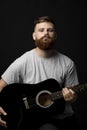 Portraite of handsome stylish bearded men with a acoustic guitar on a white background. Music performer musician