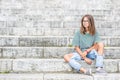 Portraito of young girl in a free modern outfit from jeans with holes