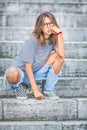 Portraito of young girl in a free modern outfit from jeans with holes