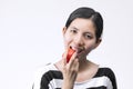 Portraits Cute Asiam Woman Eating Tomato. Royalty Free Stock Photo