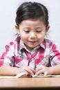 Portraits Cute Asian Girl playing on wooden table.