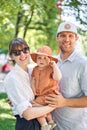 Portraits happy family. Young mother, father and their daughter of acute 10 months old baby girl. Walking on the