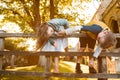 Portraits of happy kids boy and girl on wooden fence. Children playing upside down outdoors in summer park. Kids happy Royalty Free Stock Photo