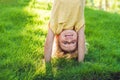 Portraits of happy kids playing upside down outdoors in summer p Royalty Free Stock Photo