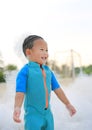 Portraits of happy little Asian baby boy smiling having fun in Foam Party at the pool outdoor