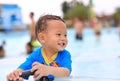 Portraits of little Asian baby boy smiling having fun in the pool outdoor