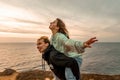 Portraits of lovers, romantic couple of lovers hugging, kissing, touching, eye contact at sunset, sunrise against the Royalty Free Stock Photo
