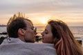 Portraits of lovers, romantic couple of lovers hugging, kissing, touching, eye contact at sunset, sunrise against the Royalty Free Stock Photo