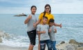 Portraits of mothers and children standing on the rock with the background of the sea