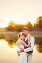 Portraits of a newly married couple. The wedding couple is standing on the background of the order.