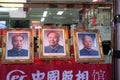 Portraits of three famous Chinese politicians in shop window on famous Wangfujing Street in central Beijing