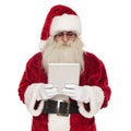 Portrat of happy santa claus looking at a tablet