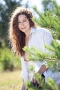 Portrat of pretty woman with curly disheveled hair and naked breast, female standing in sunny forest Royalty Free Stock Photo