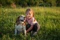Portrert cute girl 4 years old with a dog beagle in the park on the grass in the summer Royalty Free Stock Photo