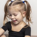 Portret of a beautiful emotional 4 year old girl with two ponytails