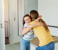 child mother daughter backpack house education school family student welcome hug together love woman elementary home Royalty Free Stock Photo