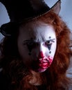 Portriat of a Young woman ins scary clown make up. Royalty Free Stock Photo