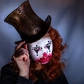 Portriat of a Young woman ins scary clown make up. Royalty Free Stock Photo