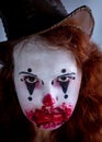 Portriat of a Young woman ins scary clown make up. Royalty Free Stock Photo