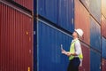 Portrait worker engineer hold a laptop and walking to checking the containers box