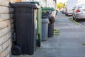 06/25/2020 Portsmouth, Hampshire, UK black wheelie bins and green recycling bins outside homes ready for collection