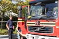 A British Fire engine from hampshire fire service with a firefighter stood near it