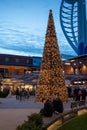 12/15/2019 Portsmouth, Hampshire, UK The Christmas tree surrounded by shoppers at Gunwharf Quays, Portsmouth with the Spinnaker