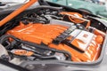 A close up of an orange Volkswagen or VW motor car engine which has been tuned up